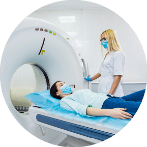 Radiologist with a female patient in the room of computed tomography