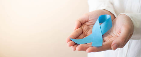 Men's health and Prostate cancer awareness campaign in November month  Close up of young man hands holding light blue ribbon awareness  Symbol for support men who living w  cancer  Copy space 