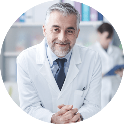 Smiling confident doctor at the reception desk, medical staff working on the background
