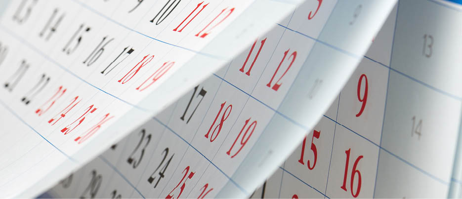 Flipping of sheets of calendar with black and red numbers